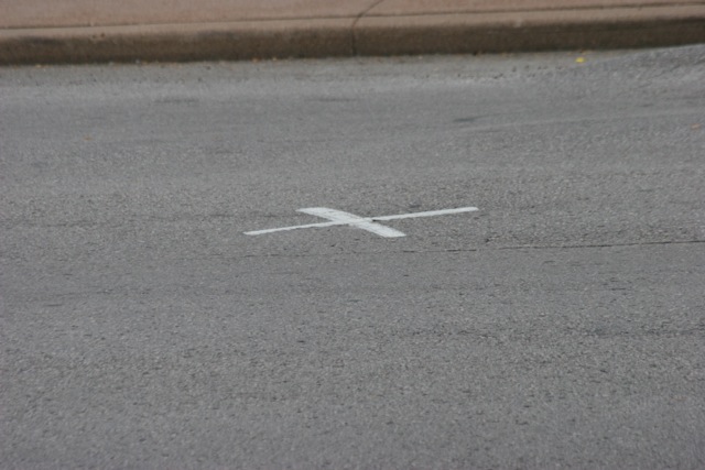 One of the two marks in the roadway (they were supposedly 'unofficial and were removed in a repaving shortly before today 11/22/2013).