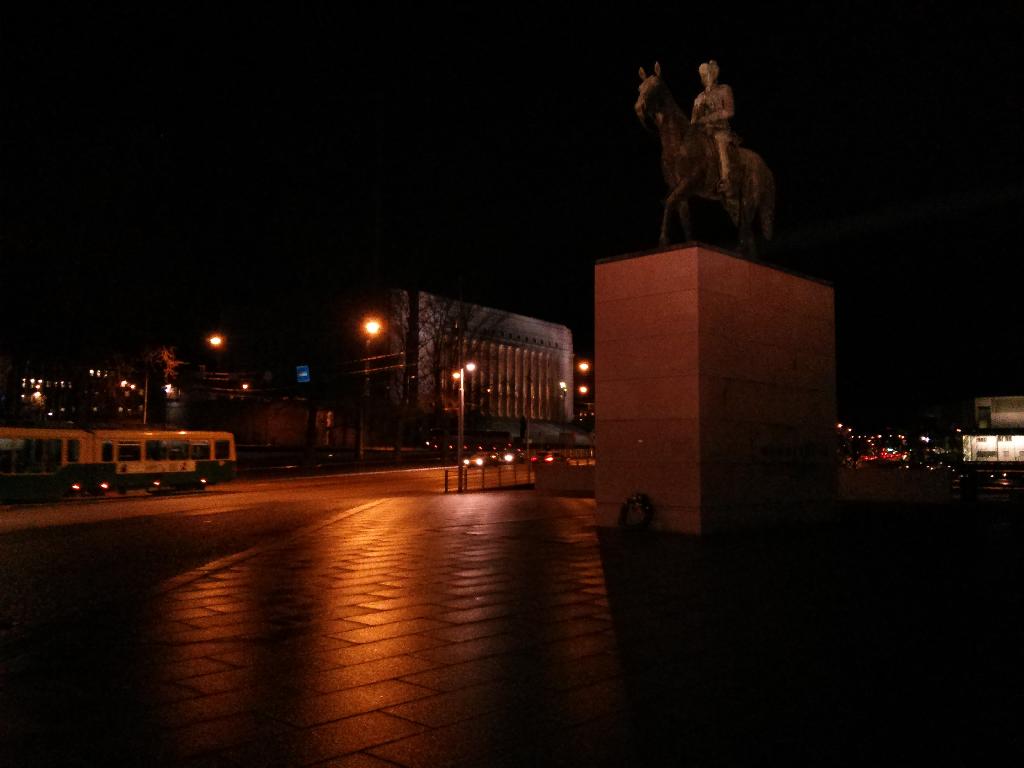 Statue of Carl Gustaf Emil Mannerheim and the Finnish Parliament building in the background