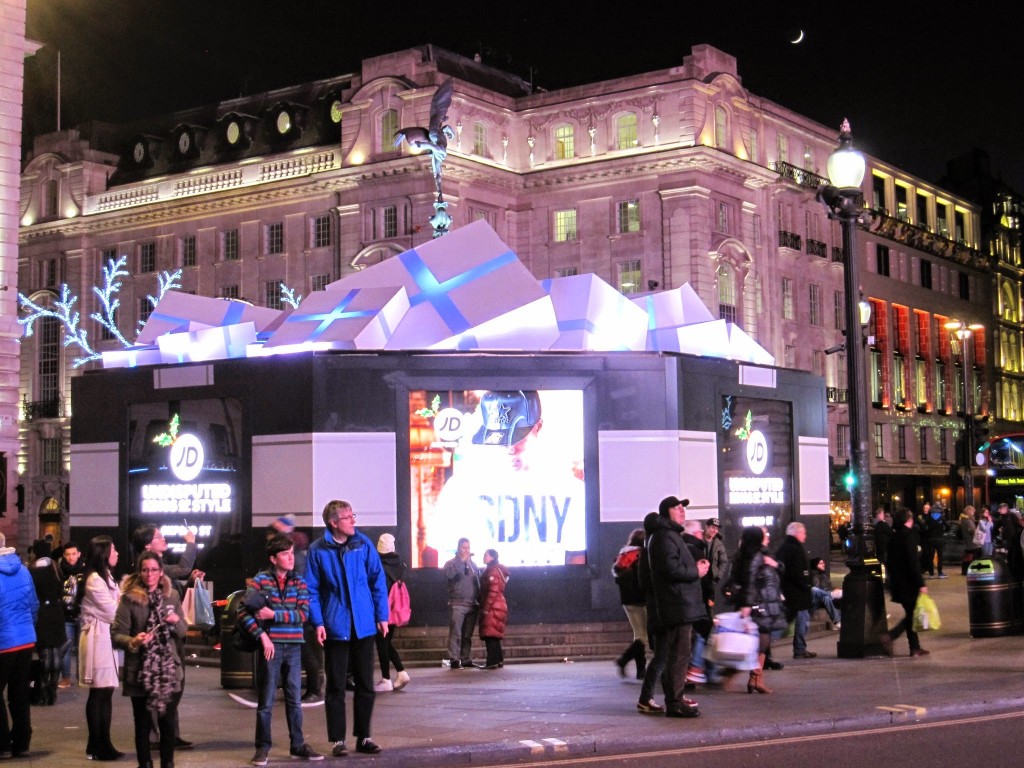 Eros statue in Piccadilly Circus surrounded by Christmas presents