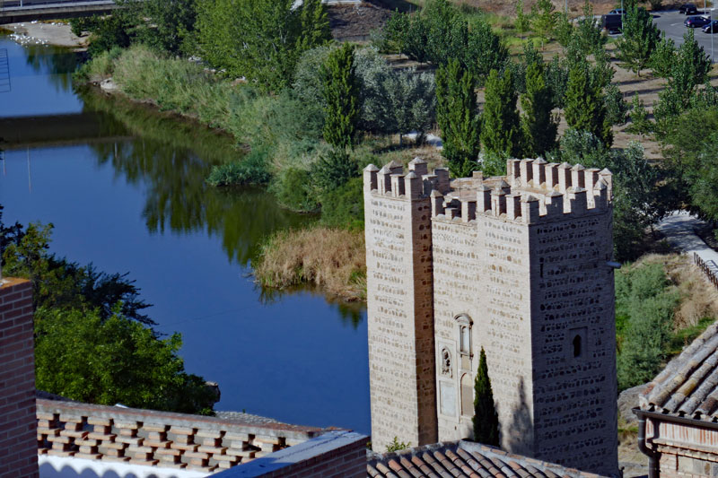 A view from up on the hill just by the Alcazar de Toledo down towards the Tagus river and the Alcántara bridge and gate.