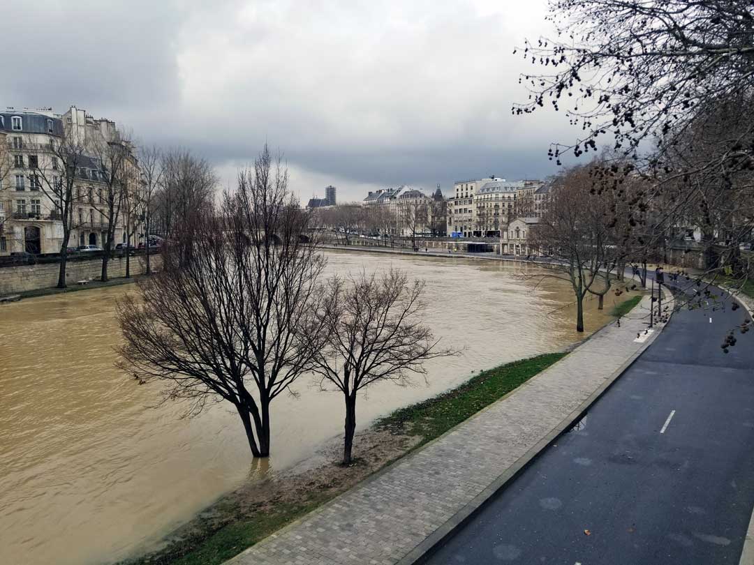 Looking out over the river Seine with Ice St-louis in the background, notice the trees underwater in the foreground, that is normally a parklike area with a walkway.