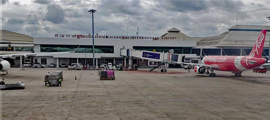  Chiang Mai airport designation - CNX - with the terminal building as seen from the tarmac.