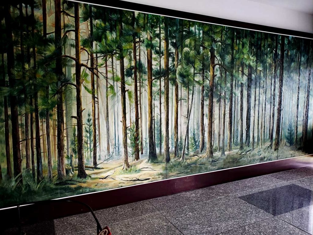 A nice Pine forest adorns the wall behind the Grand Piano.